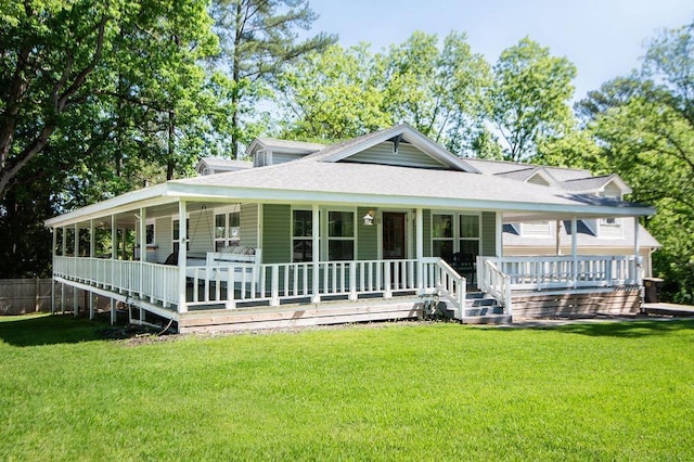 rear view of house featuring a lawn and covered porch