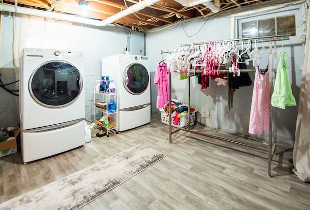 washroom featuring wood-type flooring and separate washer and dryer