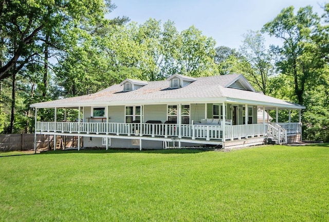 rear view of house featuring a lawn