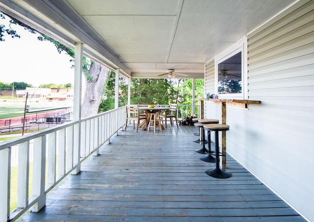 wooden terrace featuring ceiling fan and covered porch