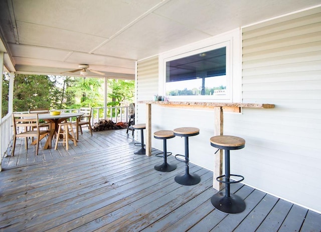 wooden deck featuring ceiling fan