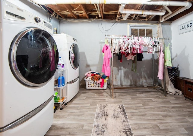 washroom featuring washer and clothes dryer and light wood-type flooring