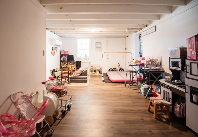 basement with wood-type flooring and an AC wall unit