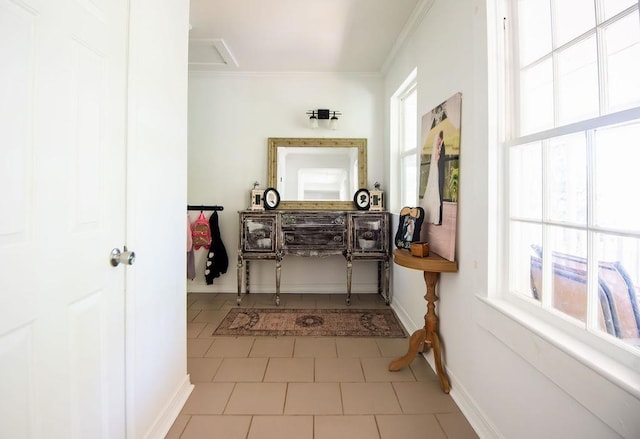 hall with ornamental molding and light tile patterned floors