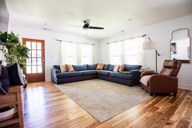 living room featuring hardwood / wood-style flooring and ceiling fan