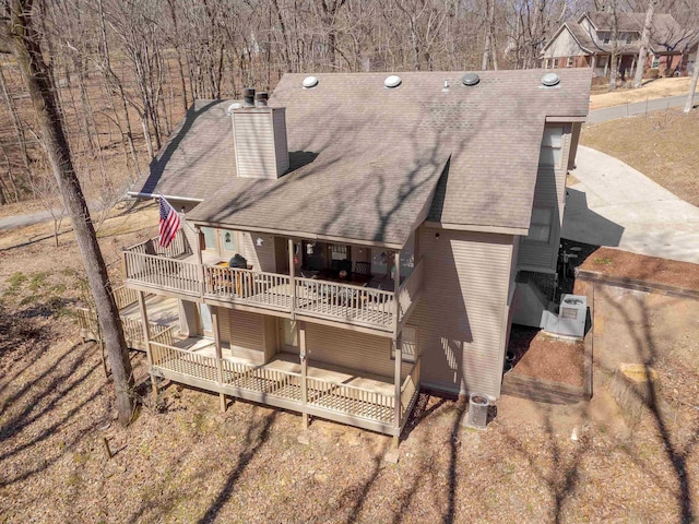 back of property with a patio, a chimney, and a balcony