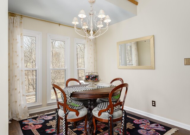 dining area with a chandelier, baseboards, and wood finished floors