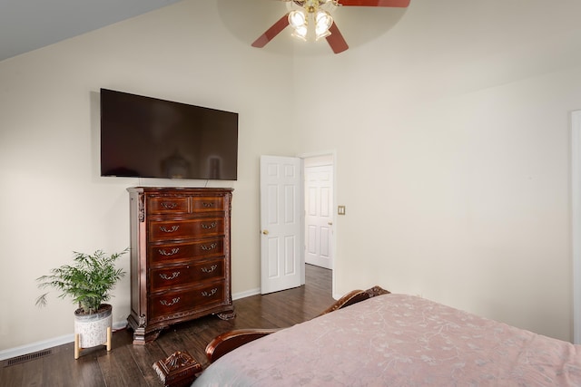 bedroom with a ceiling fan, baseboards, visible vents, and wood finished floors