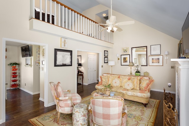 living area with a ceiling fan, high vaulted ceiling, baseboards, and wood finished floors