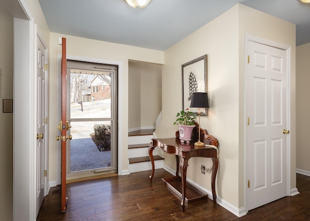 foyer entrance featuring baseboards and hardwood / wood-style floors