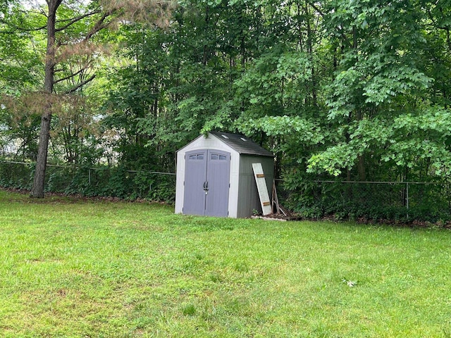 view of shed featuring fence