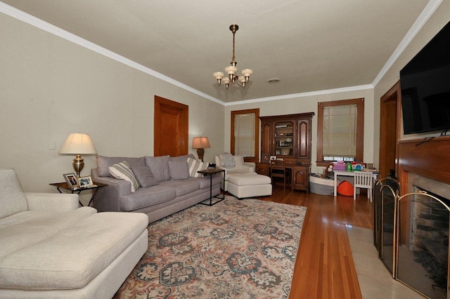 living room featuring ornamental molding, dark wood-type flooring, and an inviting chandelier