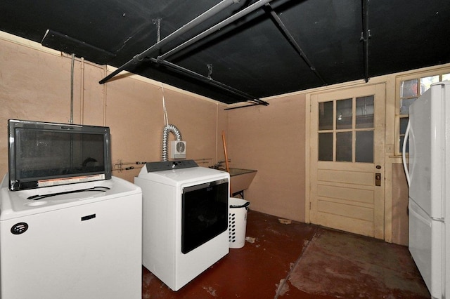 laundry room featuring independent washer and dryer and sink