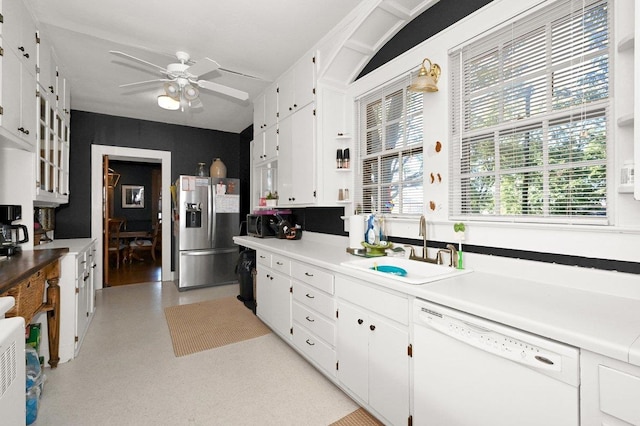 kitchen with white cabinets, dishwasher, stainless steel fridge, and sink