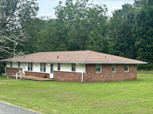 - view of front of house with brick siding, a front yard, and a porch