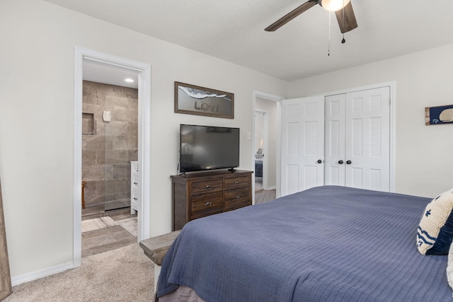 carpeted bedroom with ceiling fan, a textured ceiling, and a closet