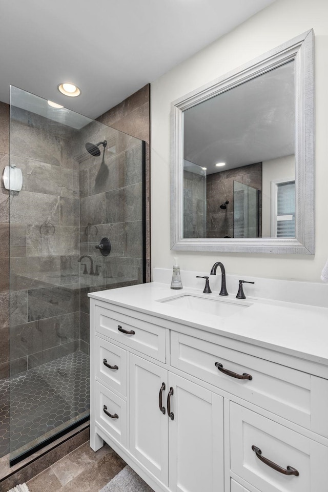 bathroom featuring vanity and a tile shower