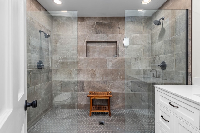 bathroom with vanity and tiled shower