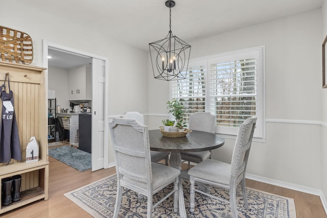 dining area featuring a notable chandelier and light hardwood / wood-style flooring