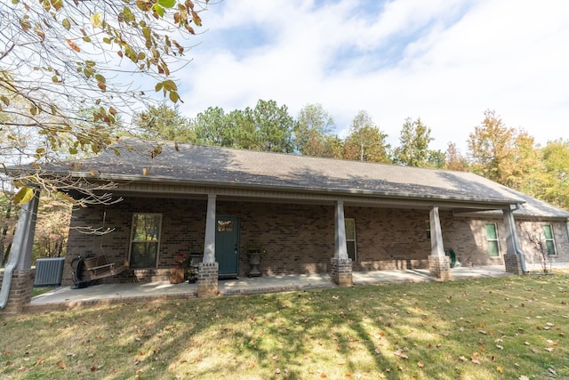 back of property featuring a yard, cooling unit, and a patio area