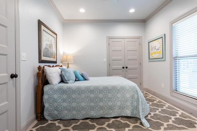 bedroom featuring a closet and crown molding