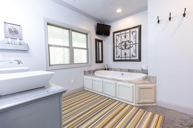 bathroom with a bathing tub, crown molding, and double sink