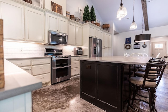 kitchen with a center island, stainless steel appliances, pendant lighting, decorative backsplash, and white cabinets