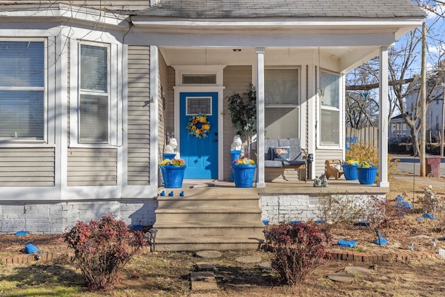 view of exterior entry featuring a porch