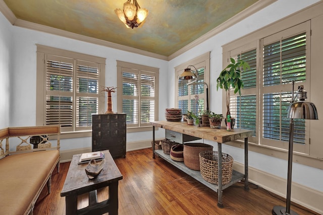 home office with wood-type flooring and ornamental molding