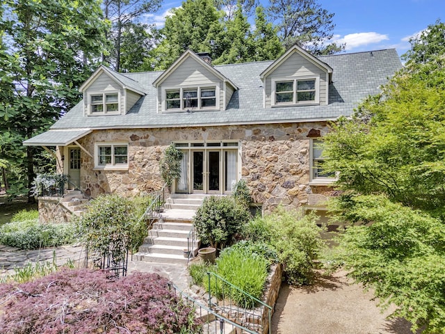 cape cod home featuring french doors