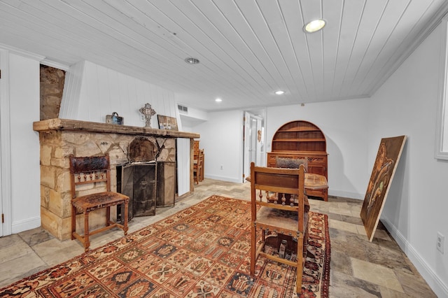 dining area featuring a fireplace and wood ceiling