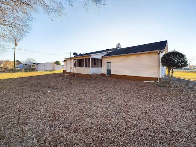 view of side of home with a sunroom