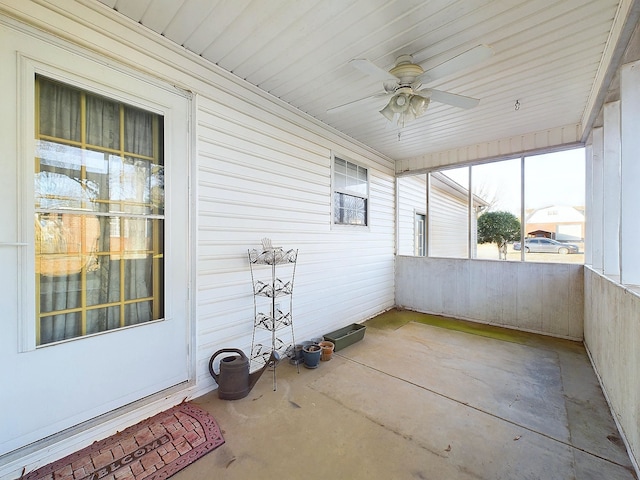 unfurnished sunroom with ceiling fan