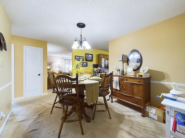 carpeted dining room with an inviting chandelier and a textured ceiling