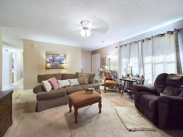 carpeted living room with a textured ceiling and ceiling fan