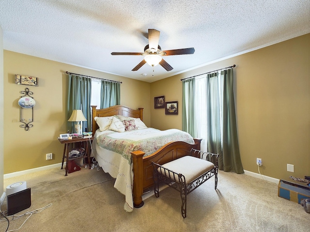 carpeted bedroom with ceiling fan and a textured ceiling