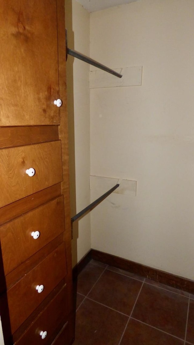  - walk in closet featuring dark tile patterned flooring