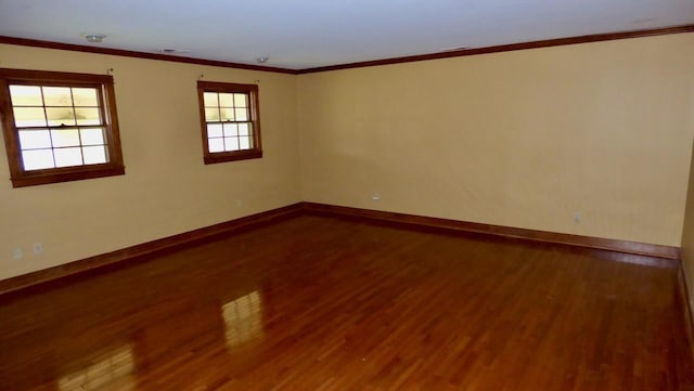  - empty room featuring baseboards, wood finished floors, and ornamental molding
