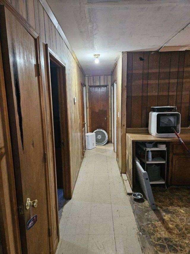  - hall featuring wood walls