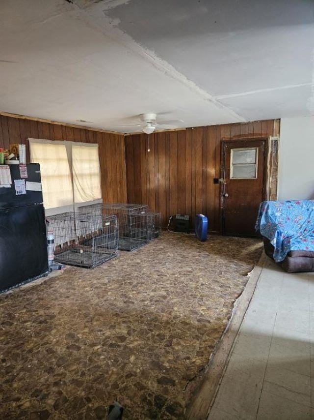  - interior space featuring wood walls and ceiling fan