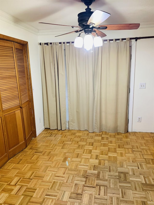 unfurnished bedroom with ceiling fan, ornamental molding, and light parquet floors