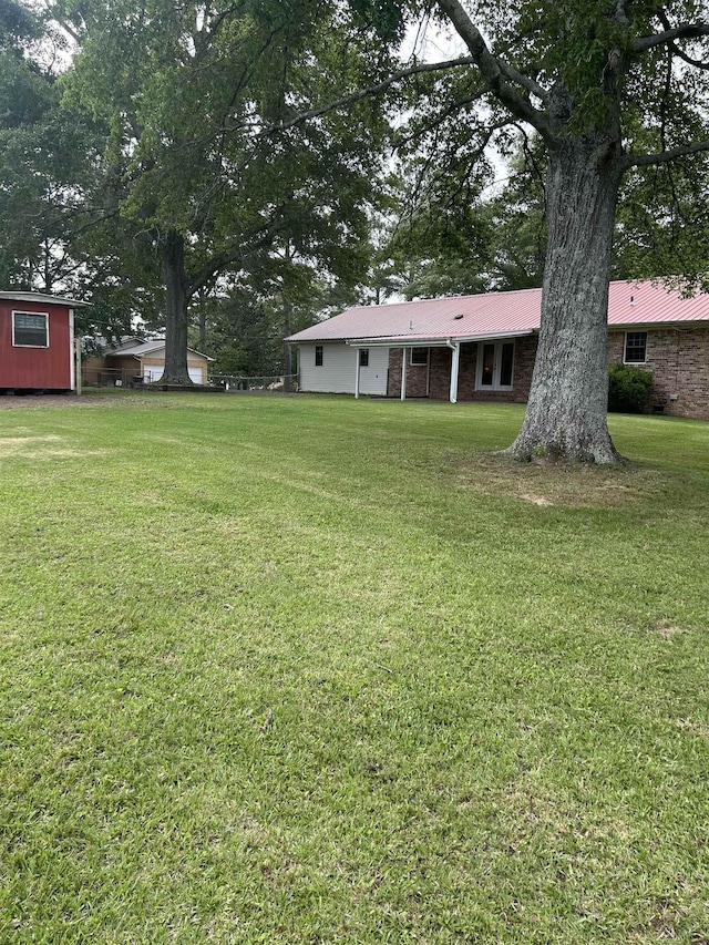  - view of green lawn with an outdoor structure