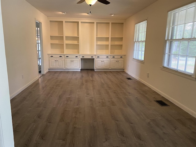  - unfurnished living room featuring ceiling fan, dark wood-type flooring, and baseboards