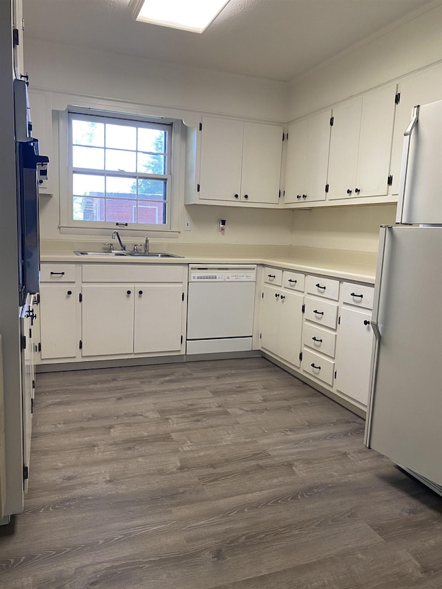 - kitchen with white appliances, a sink, dark wood-style flooring, and white cabinetry