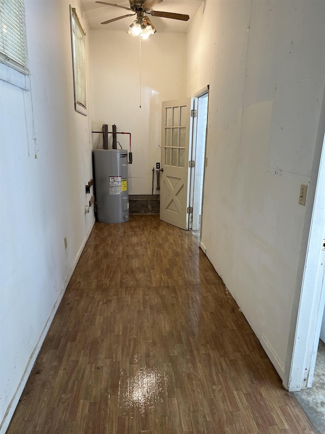  - hallway featuring water heater, wood finished floors, and a high ceiling