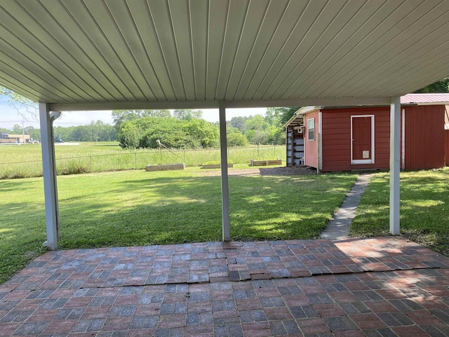  - view of patio featuring an outbuilding