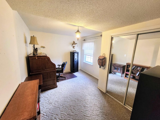 hallway with carpet and a textured ceiling