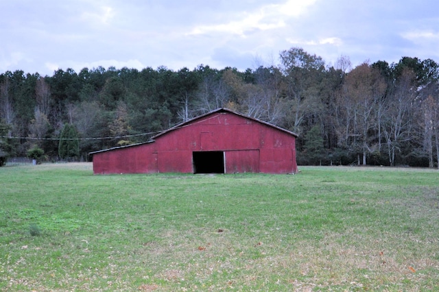 view of outbuilding featuring a yard