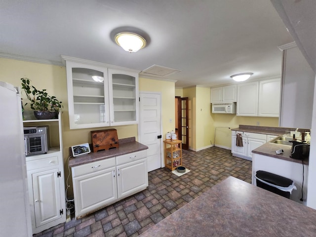 kitchen featuring crown molding, sink, white cabinets, and white appliances