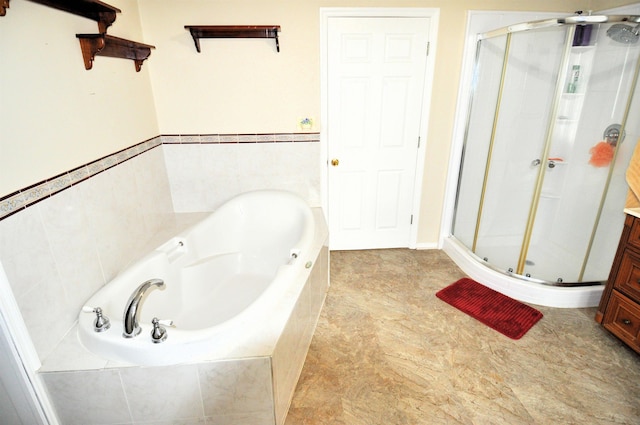 bathroom with separate shower and tub and vanity